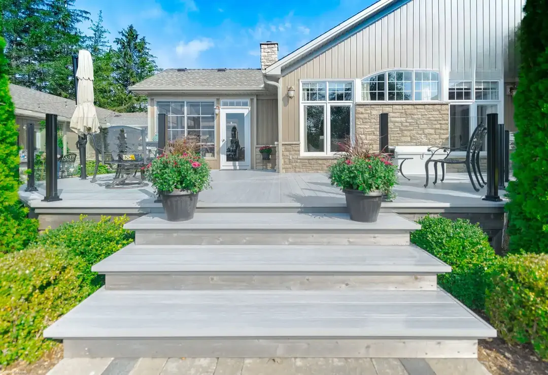 A well constructed deck featuring steps that lead to a house, emphasizing a contemporary Decking System.