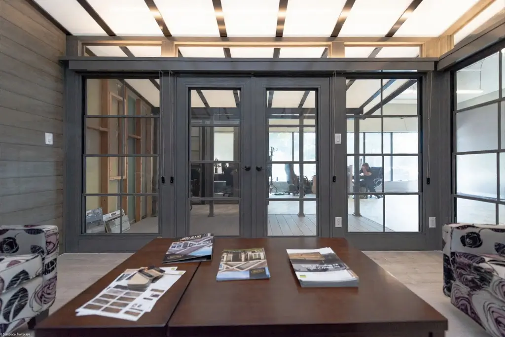 A cozy living room with a table and chairs, highlighted by WeatherMaster™ Doors enhancing the space.