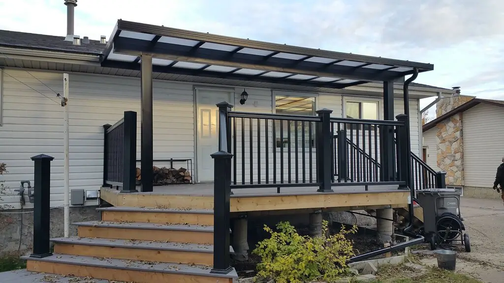 A deck showcasing a pergolized awning, steps, and modern Railing Systems, perfect for enjoying outdoor moments.