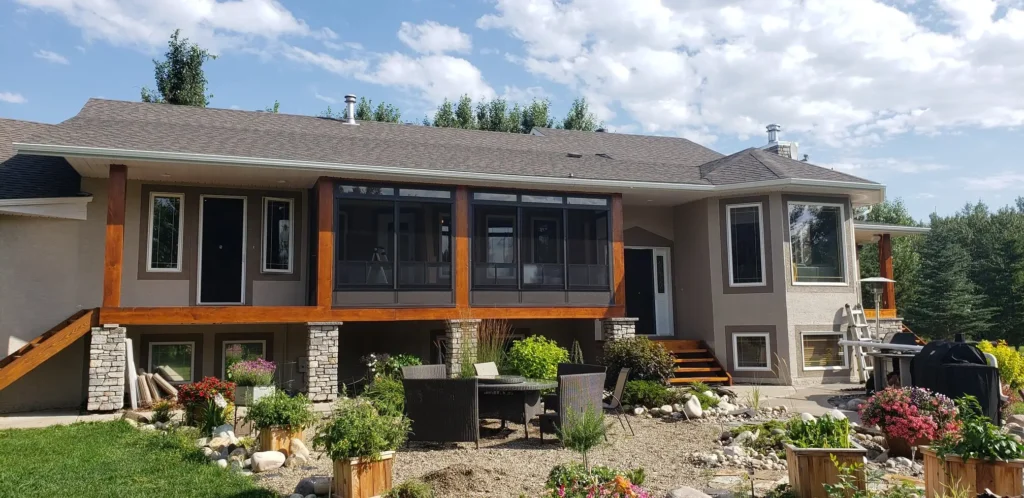 Exterior view of a house with a patio and deck, showcasing a Retractable Screen for added privacy.