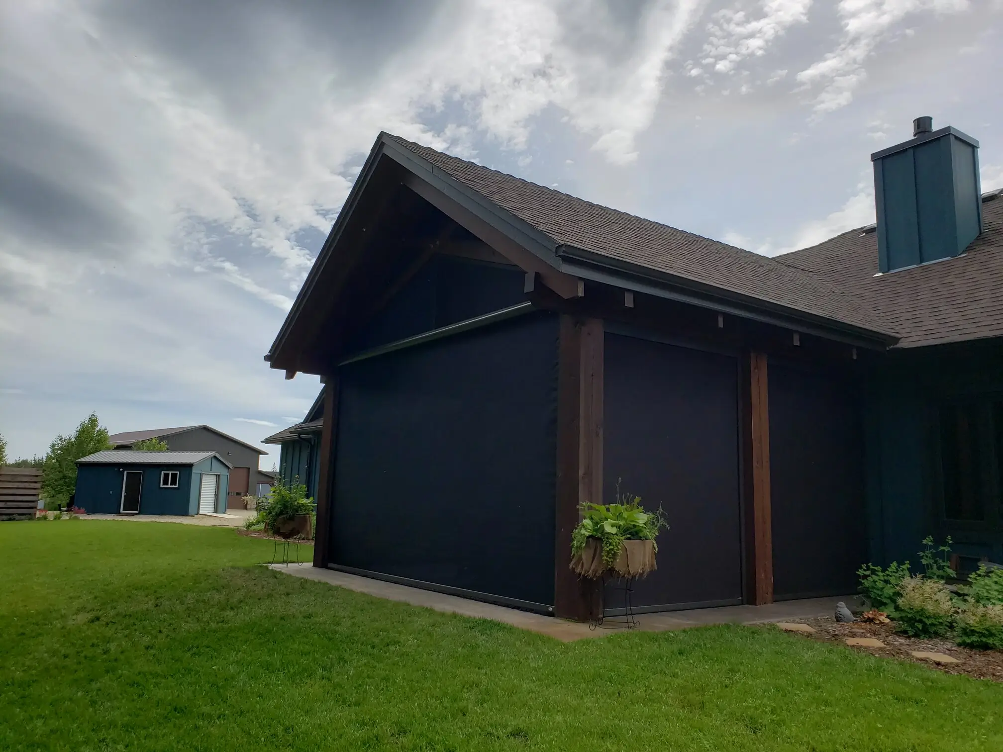A residence with a prominent garage door and an expansive patio equipped with a Retractable Screen for added convenience.