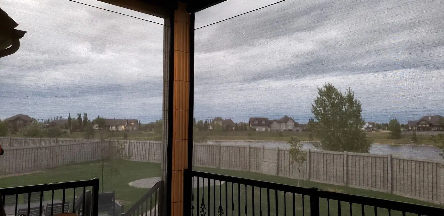 A tranquil patio overlooking the sky, featuring an integrated screen that blends indoor and outdoor spaces.
