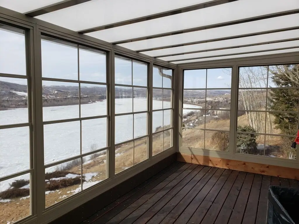 Bright 3-Season Sunroom featuring vinyl walls and a picturesque view of the tranquil lake outside.