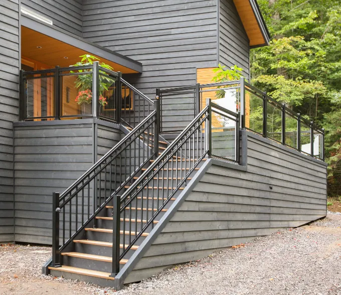 Black aluminum stair and deck railing with glass panels